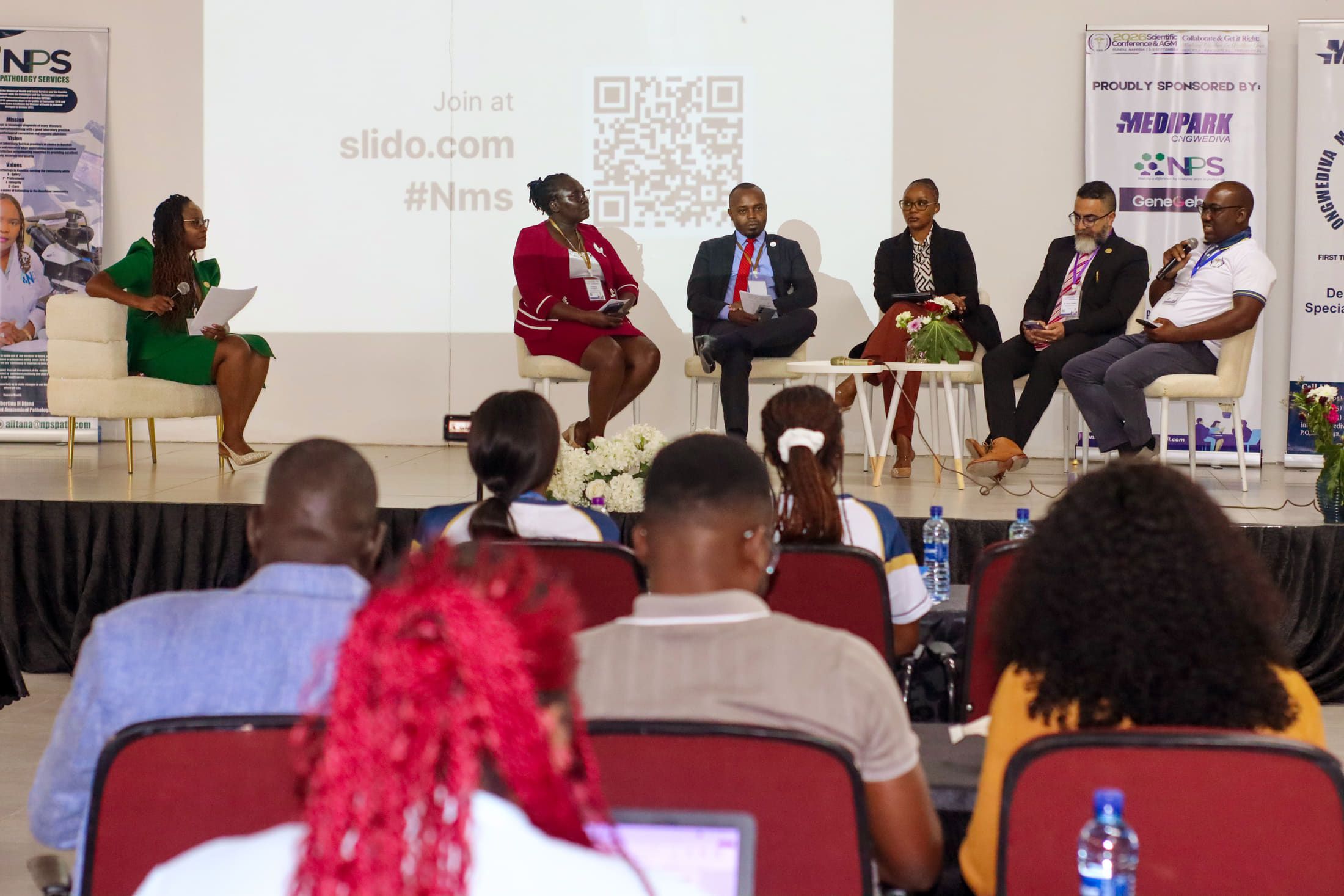 A panel discussion at the 2026 NMS Scientific Conference, with delegates seated in the foreground.