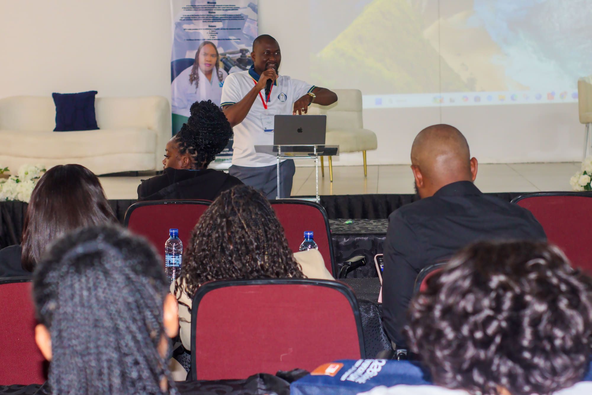A speaker addressing delegates from the lectern at an NMS meeting.